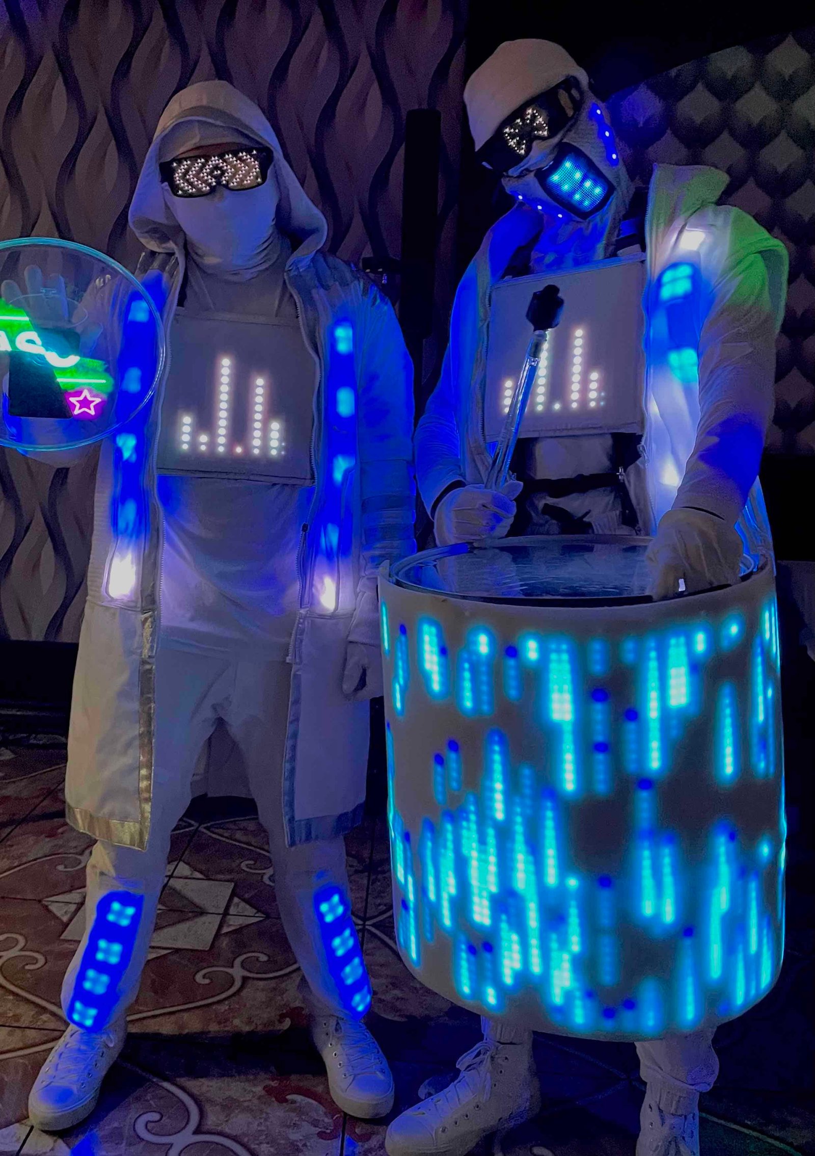 Futuristic dance crew illuminated by LED visuals at Mixd Elements event. LED dance crew with glowing costumes and neon lights showcases modern dance performances.