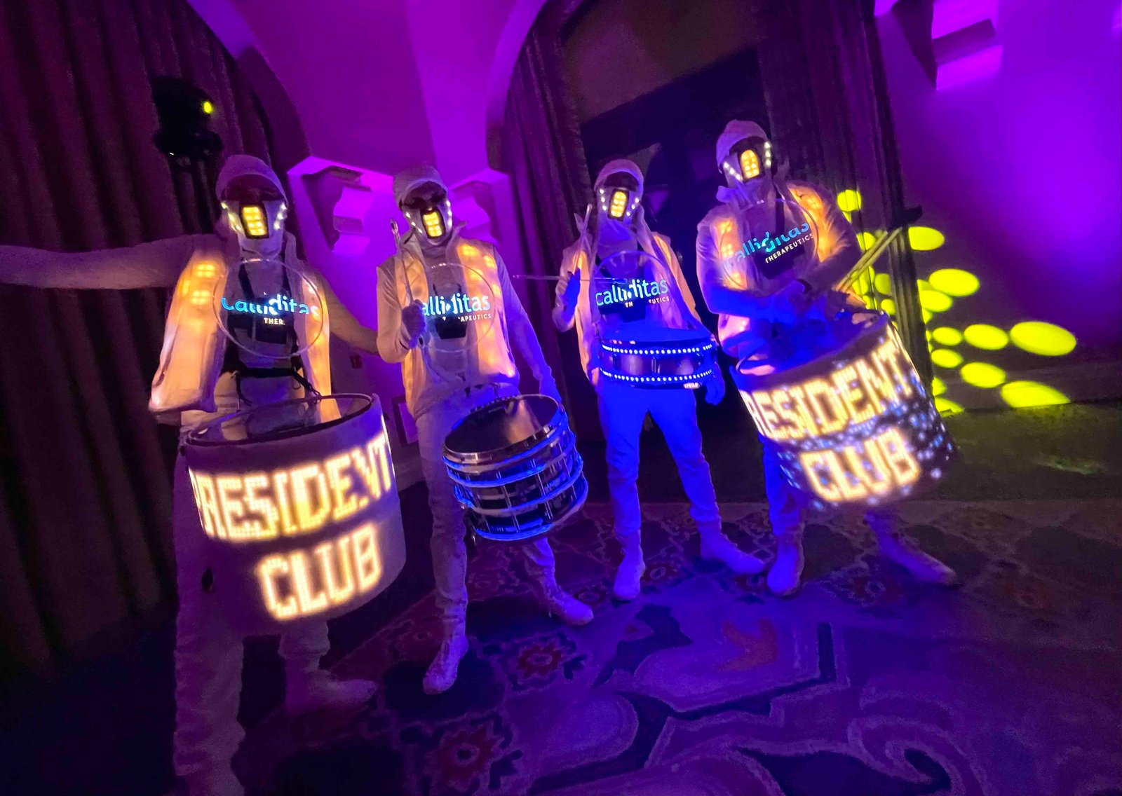 Dynamic dance crew performing with LED drums at Mixd Elements event. LED dance team performing energetic choreography with illuminated drums at a vibrant event.